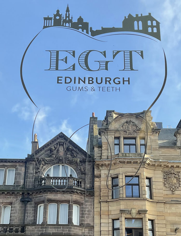 edinburgh gums and teeth logo on a window with building