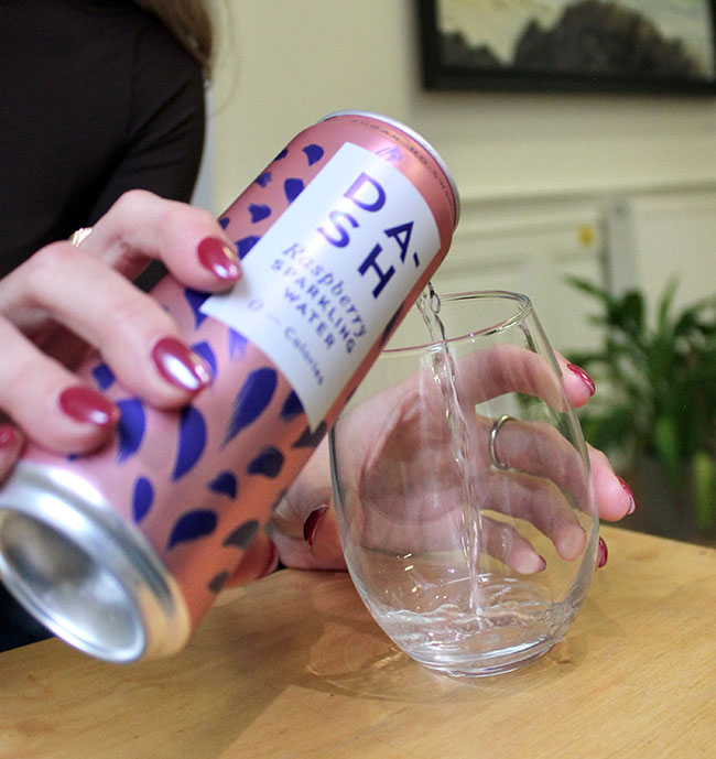 can of diet soda being poured into a glass